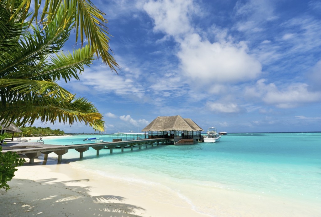 footbridge connecting with the thatched jetty in maldives island resort